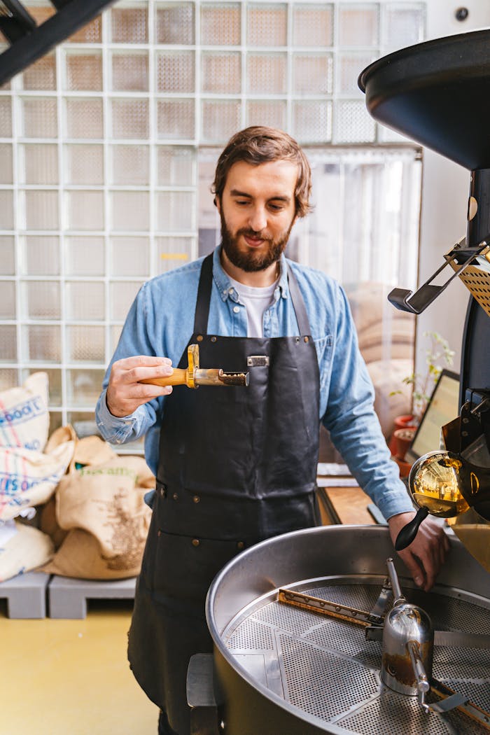 Man in Apron near Machinery in Workshop